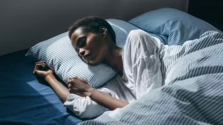 Woman sleeping with head on pillow
